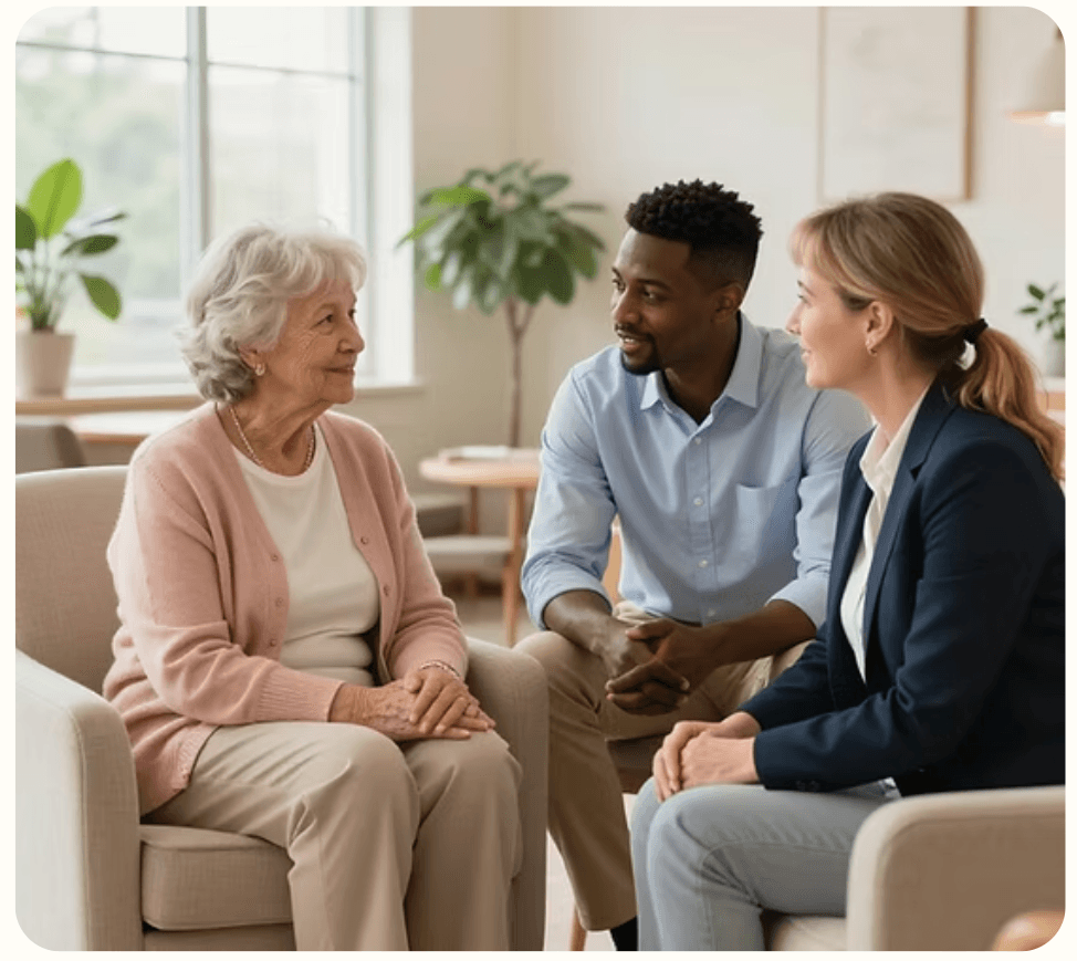An older adult speaking with two care advisors.